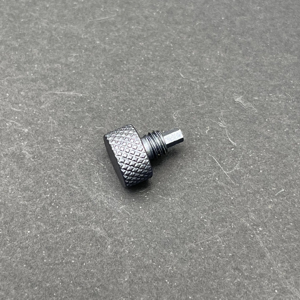 A close-up of the UV Scope Rod Wrench Tool, a small, dark gray metal tool with a textured, knurled cylindrical head and a threaded shaft with a hexagonal end.